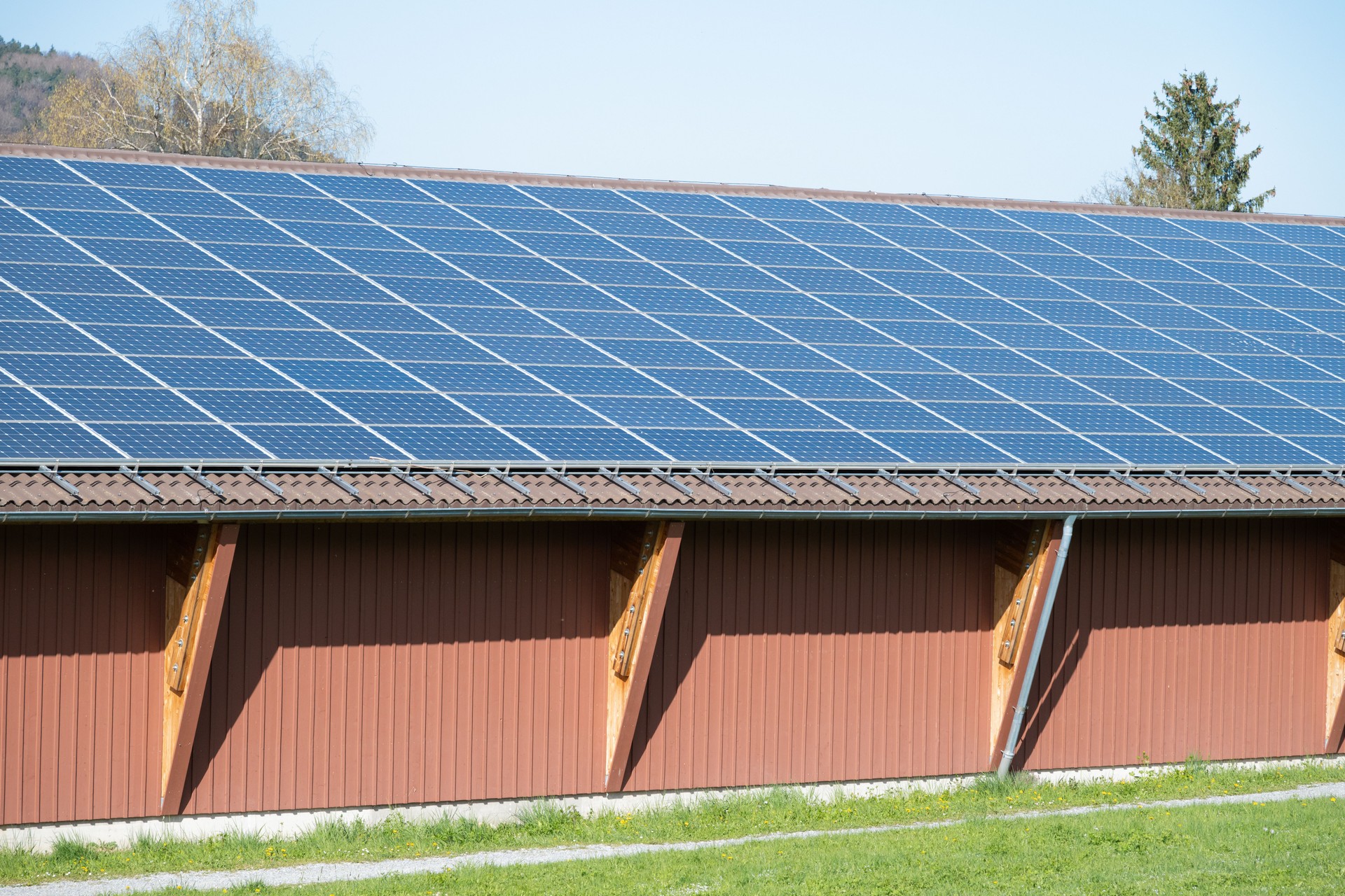 A large building with a blue solar panel roof